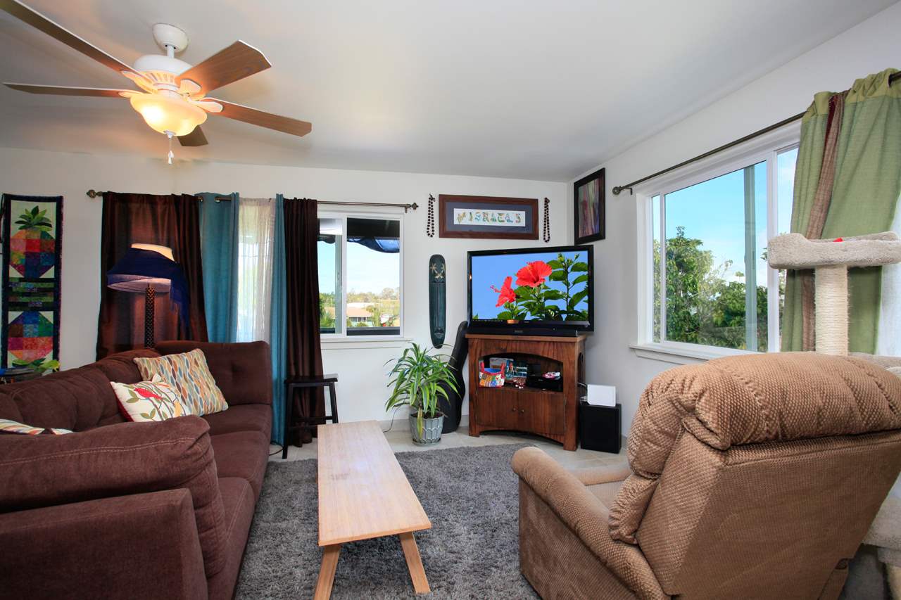 2811 Kokomo Road Haiku, HI 96708 - Photo 7 of 30 a living room with fireplace furniture and a flat screen tv