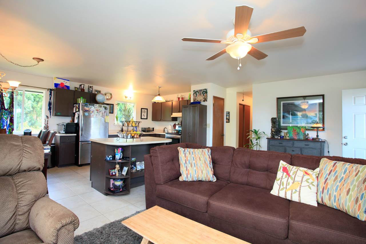 2811 Kokomo Road Haiku, HI 96708 - Photo 9 of 30 a living room with furniture kitchen view and a chandelier