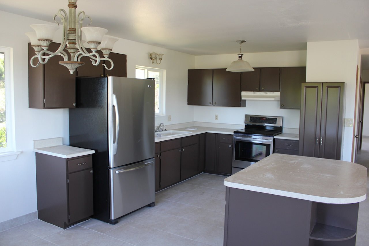 2811 Kokomo Road Haiku, HI 96708 - Photo 10 of 30 a kitchen with stainless steel appliances granite countertop a refrigerator a sink dishwasher a stove and a refrigerator