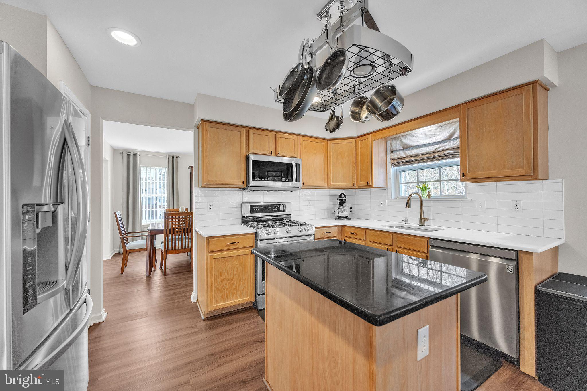 7 High Woods Avenue Sicklerville, NJ 08081 - Photo 30 of 46 a kitchen with a sink a counter top space stainless steel appliances and cabinets