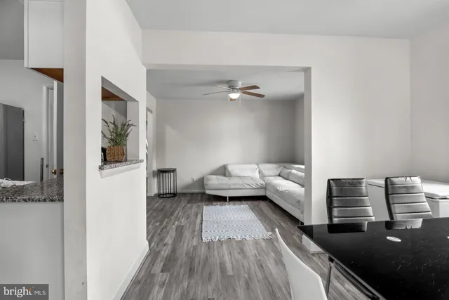 a view of a bedroom with furniture and wooden floor