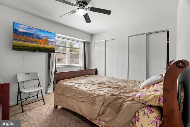 a bedroom with a bed and a painting on the wall