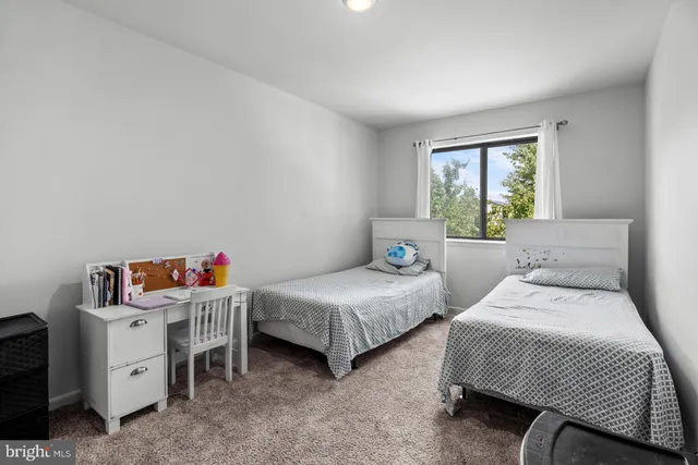 a bedroom with two beds and a window