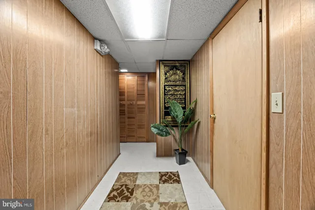 a hallway with wooden floor and windows