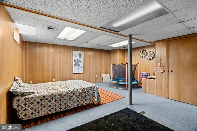 a bedroom with a bed next to a window