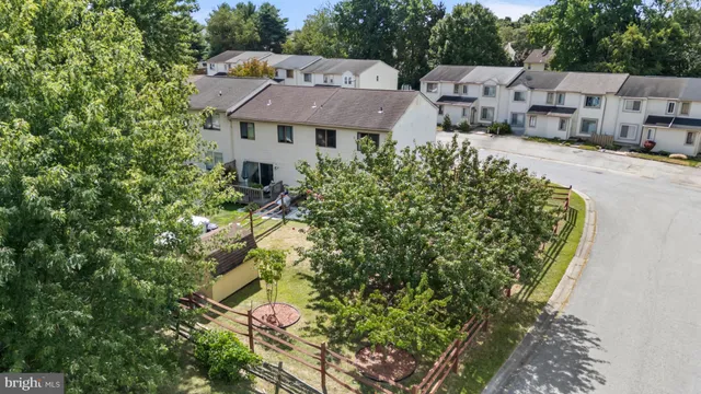 an aerial view of multiple houses with yard
