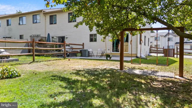 a view of a house with backyard and tree