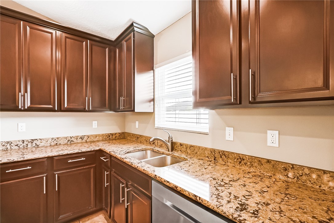 95227 Windflower Trail Fernandina Beach, FL 32034 - Photo 13 of 35 a kitchen with granite countertop cabinets sink and window
