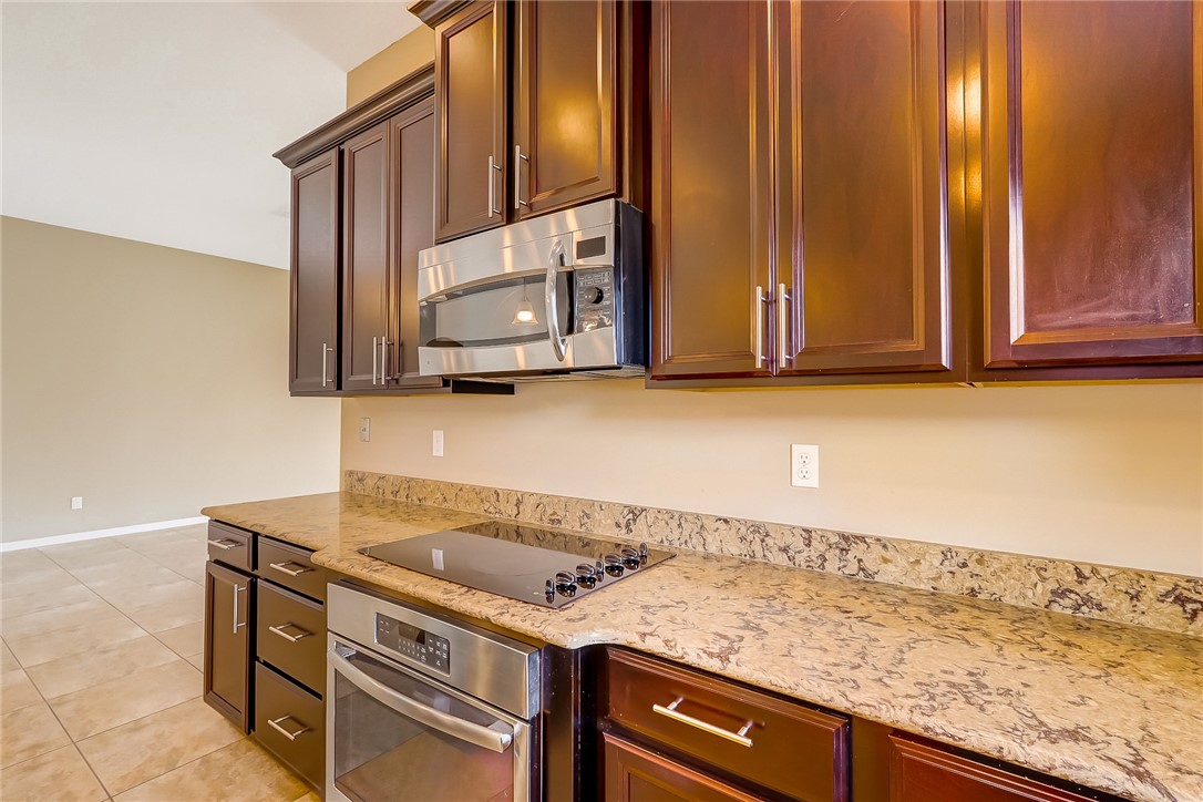 95227 Windflower Trail Fernandina Beach, FL 32034 - Photo 15 of 35 a utility room with granite countertop cabinets and a sink