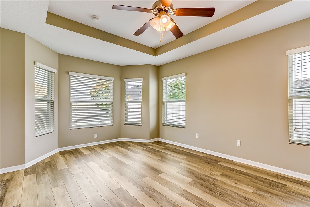 95227 Windflower Trail Fernandina Beach, FL 32034 - Photo 16 of 35 a view of empty room with wooden floor and fan