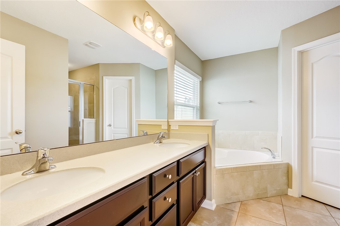 95227 Windflower Trail Fernandina Beach, FL 32034 - Photo 19 of 35 a bathroom with a tub sink and mirror