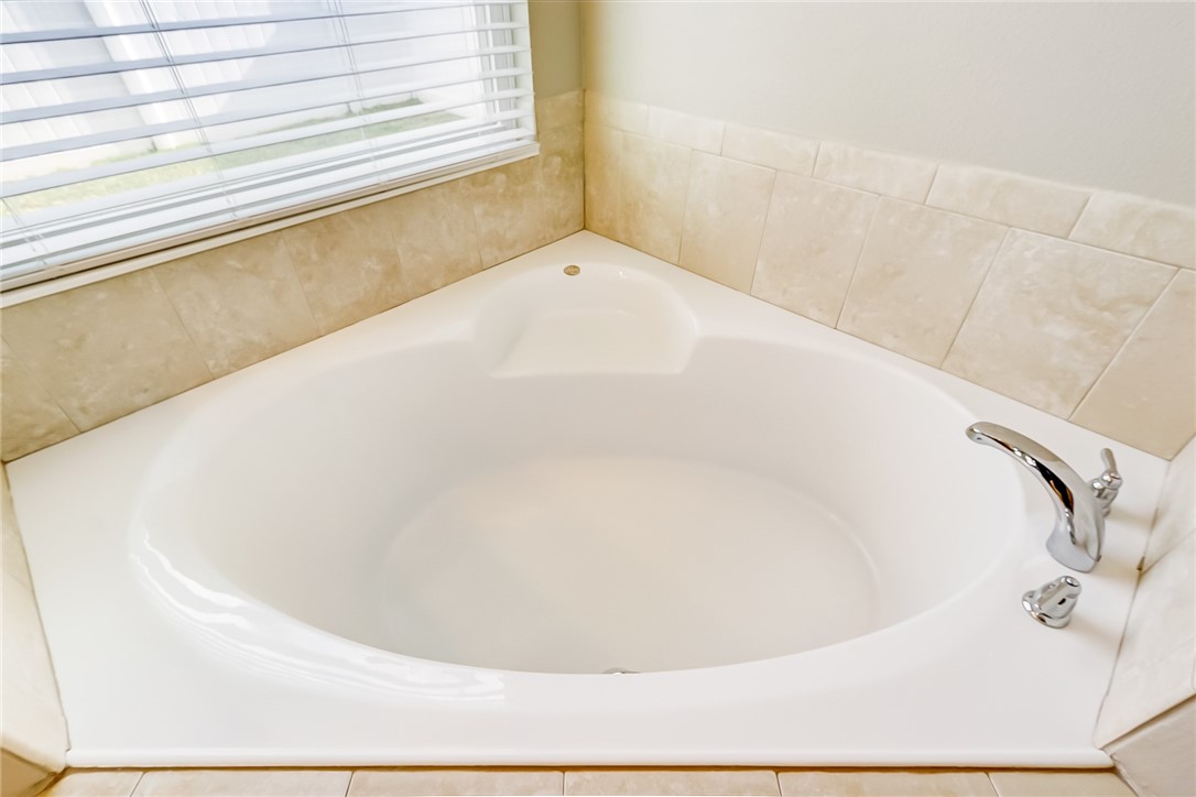 95227 Windflower Trail Fernandina Beach, FL 32034 - Photo 21 of 35 a white bath tub sitting in a bathroom