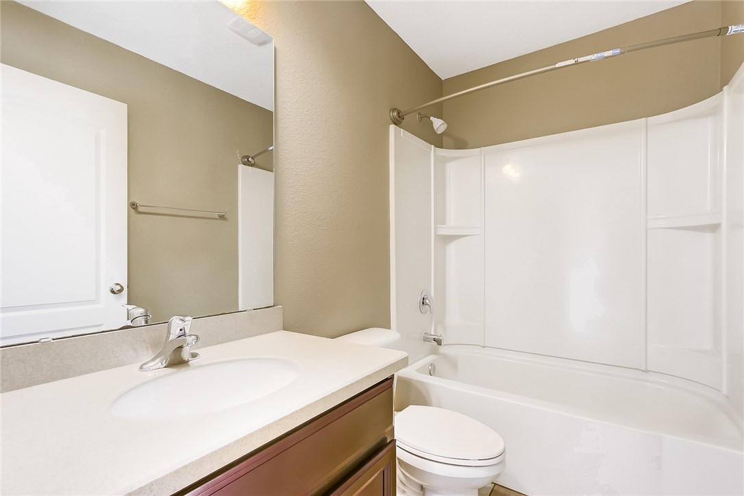 95227 Windflower Trail Fernandina Beach, FL 32034 - Photo 27 of 35 a bathroom with a bathtub shower sink vanity mirror and toilet