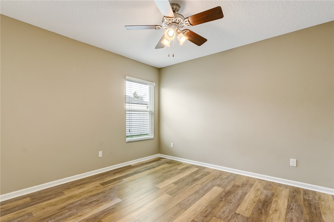 95227 Windflower Trail Fernandina Beach, FL 32034 - Photo 28 of 35 an empty room with a window and a fan