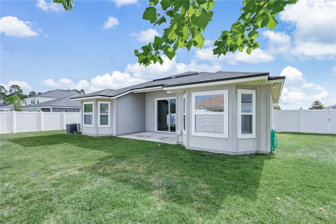 95227 Windflower Trail Fernandina Beach, FL 32034 - Photo 31 of 35 a front view of a house with a garden