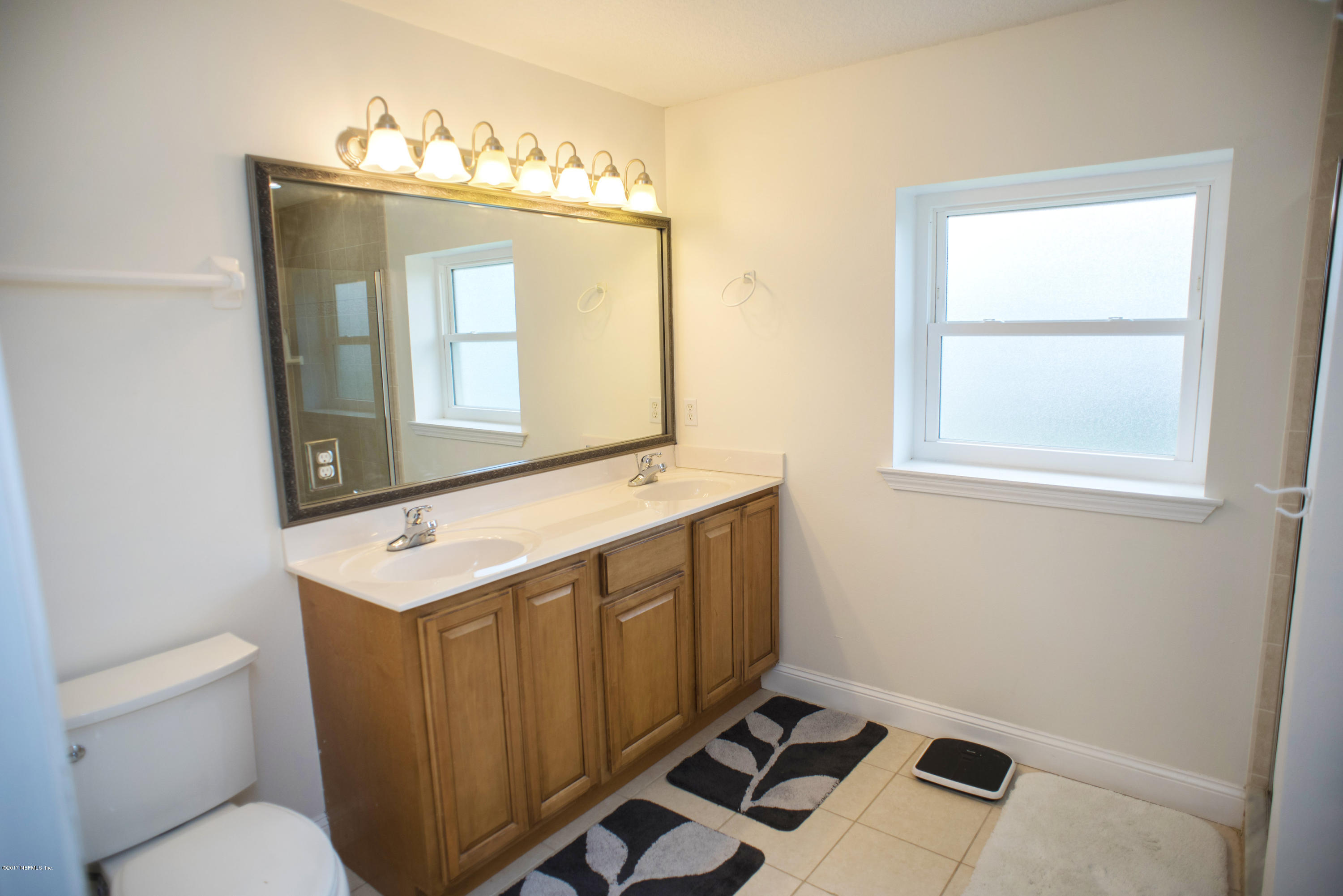 244 Barco Road St. Augustine, FL 32080 - Photo 13 of 31 a bathroom with a sink a toilet and mirror