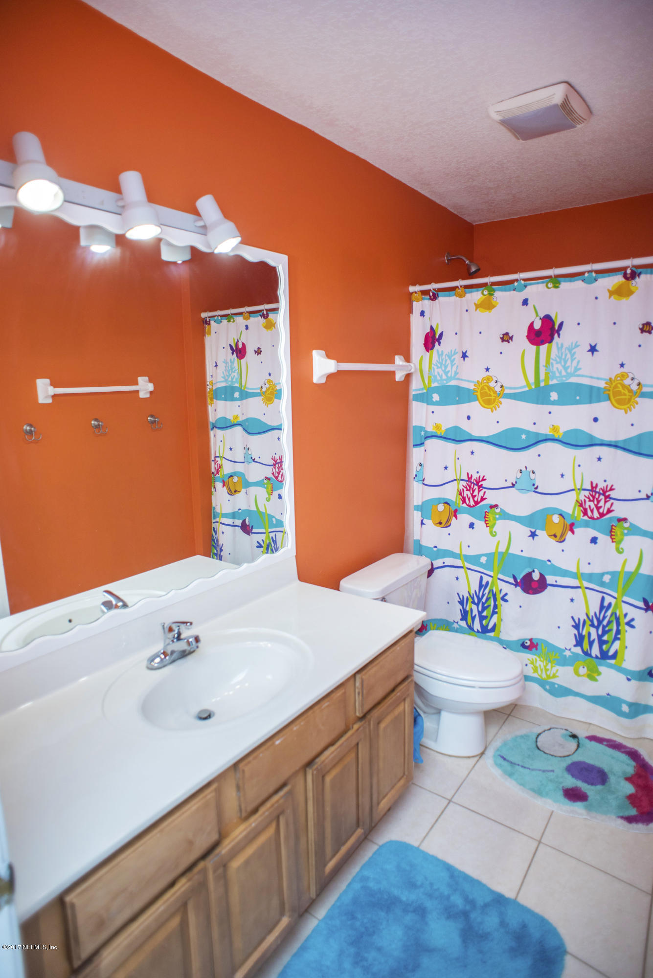244 Barco Road St. Augustine, FL 32080 - Photo 17 of 31 a bathroom with a sink a toilet and shower curtain