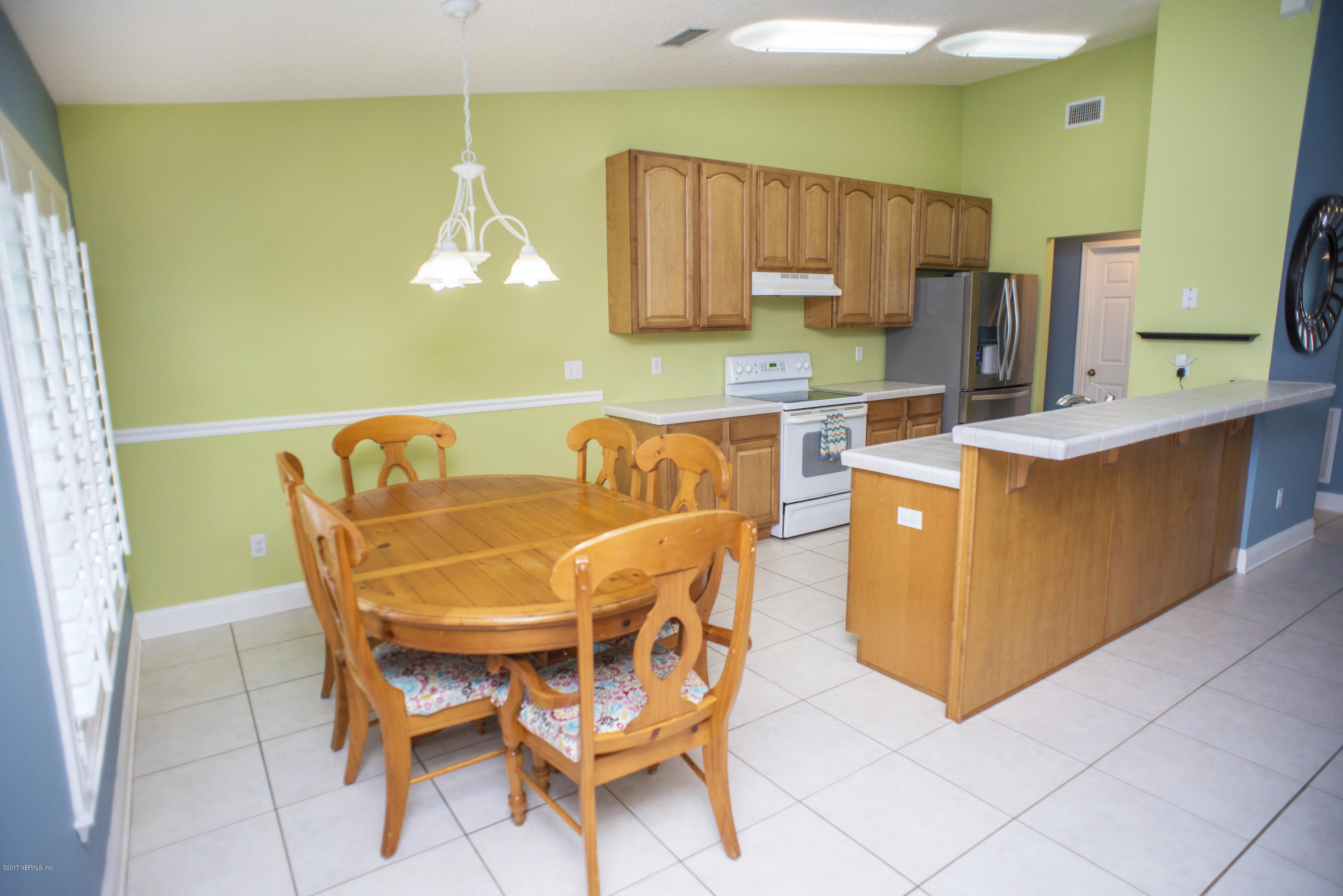 244 Barco Road St. Augustine, FL 32080 - Photo 8 of 31 a kitchen with stainless steel appliances kitchen island granite countertop a table and chairs