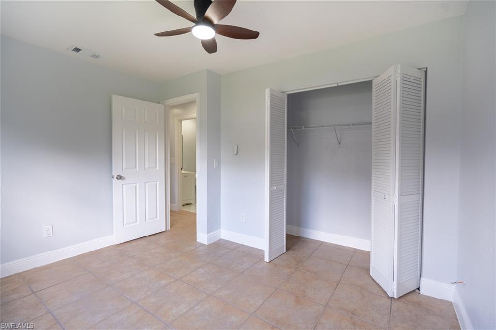 1940 48th Street Southwest Naples, FL 34116 - Photo 27 of 33 Room featuring neutral wall tones, tile flooring, and a ceiling fan with integrated lighting