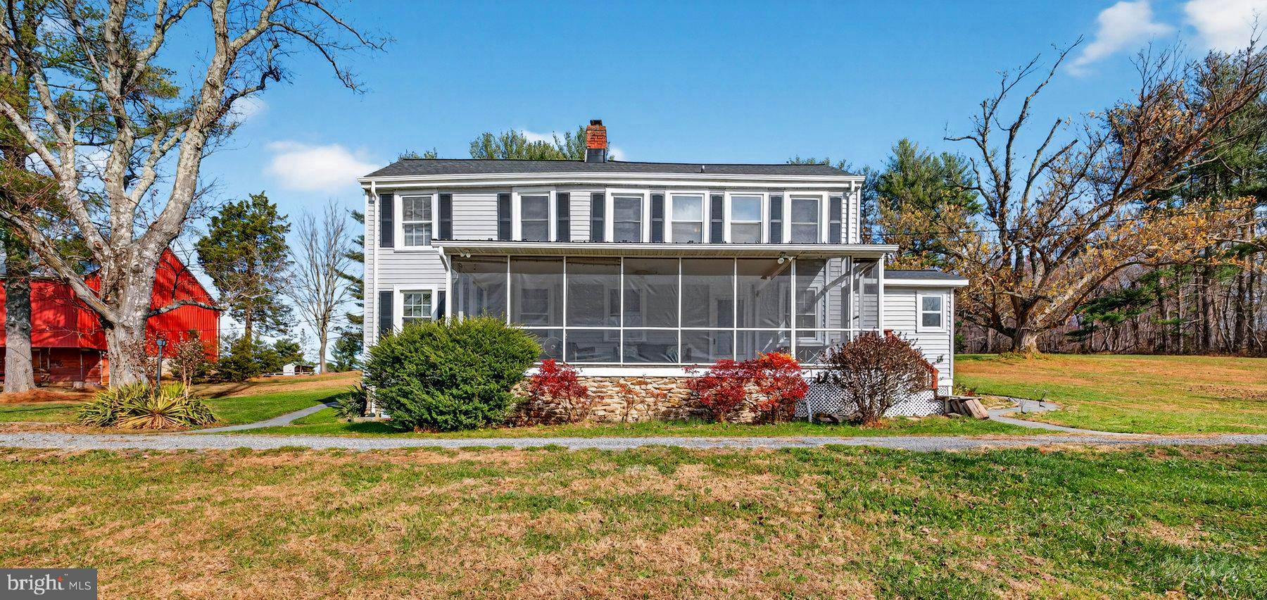 a view of a house with a yard and sitting area