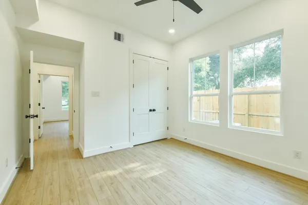 wooden floor in an empty room with a window