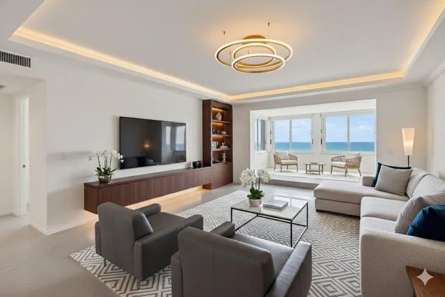 a view of living room with furniture and floor to ceiling windows