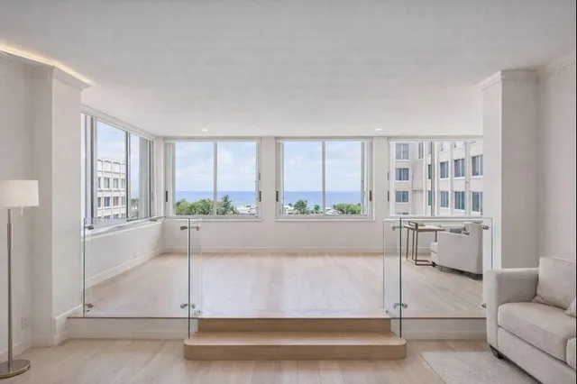 a living room with furniture a potted plant and a table