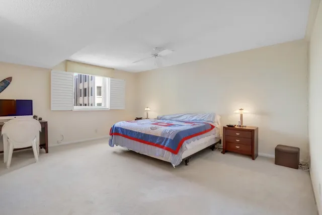 a bedroom with bed and a lamp with window