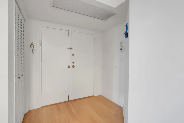 a view of a room with wooden floor and cabinet