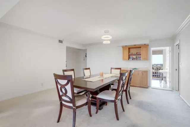 a view of a dining room with furniture and chandelier