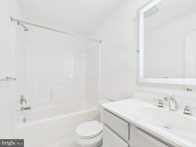 a bathroom with a sink a toilet and a bathtub