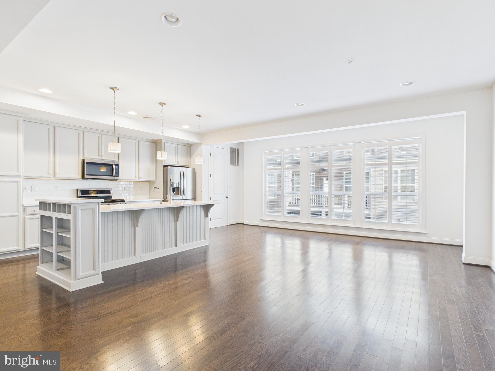 418 Mayer Place Lancaster, PA 17601 - Photo 3 of 15 a large white kitchen with wooden floors and white walls