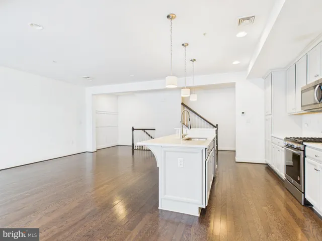 a view of a kitchen with a sink and a floor to ceiling window