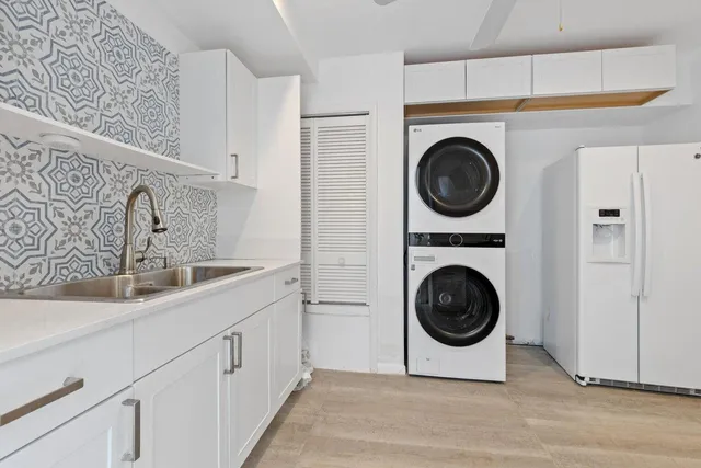 a utility room with sink dryer and washer