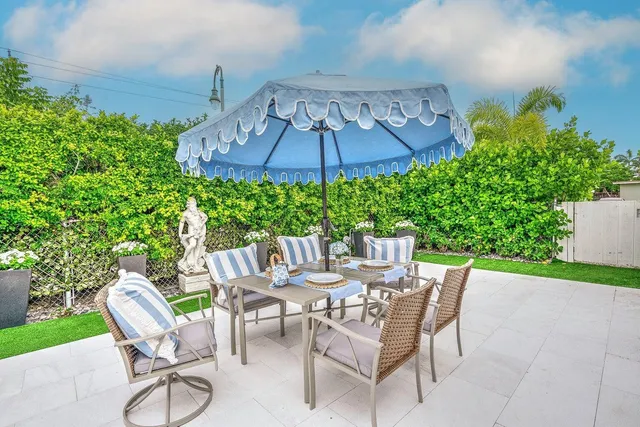 a patio with a patio table and chairs