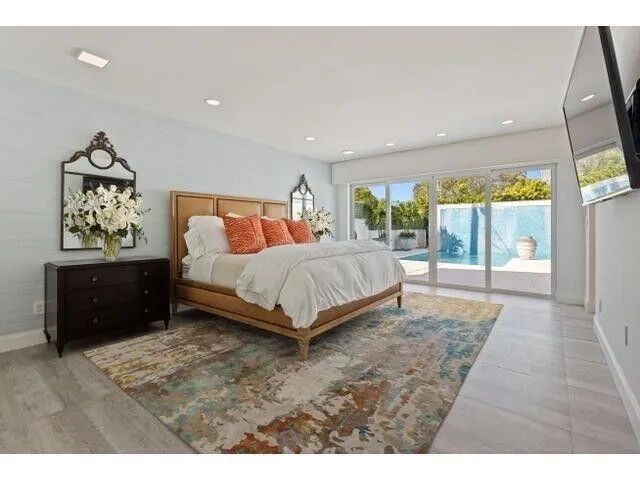 a bedroom with a bed and glass window