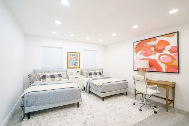 a spacious bedroom with a bed and furniture