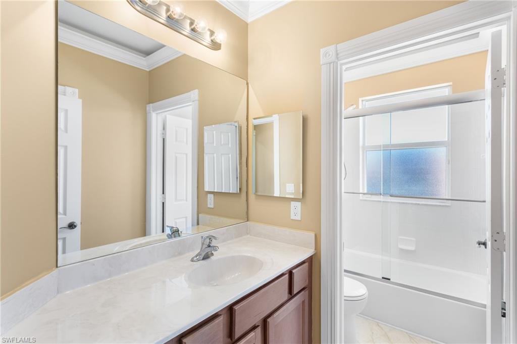 2135 Par Drive Naples, FL 34120 - Photo 12 of 46 a bathroom with a sink vanity and a mirror
