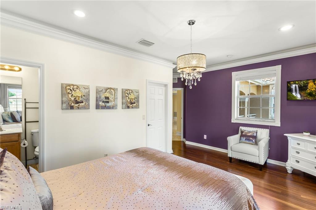 2135 Par Drive Naples, FL 34120 - Photo 13 of 46 a bedroom with a bed chandelier and a window