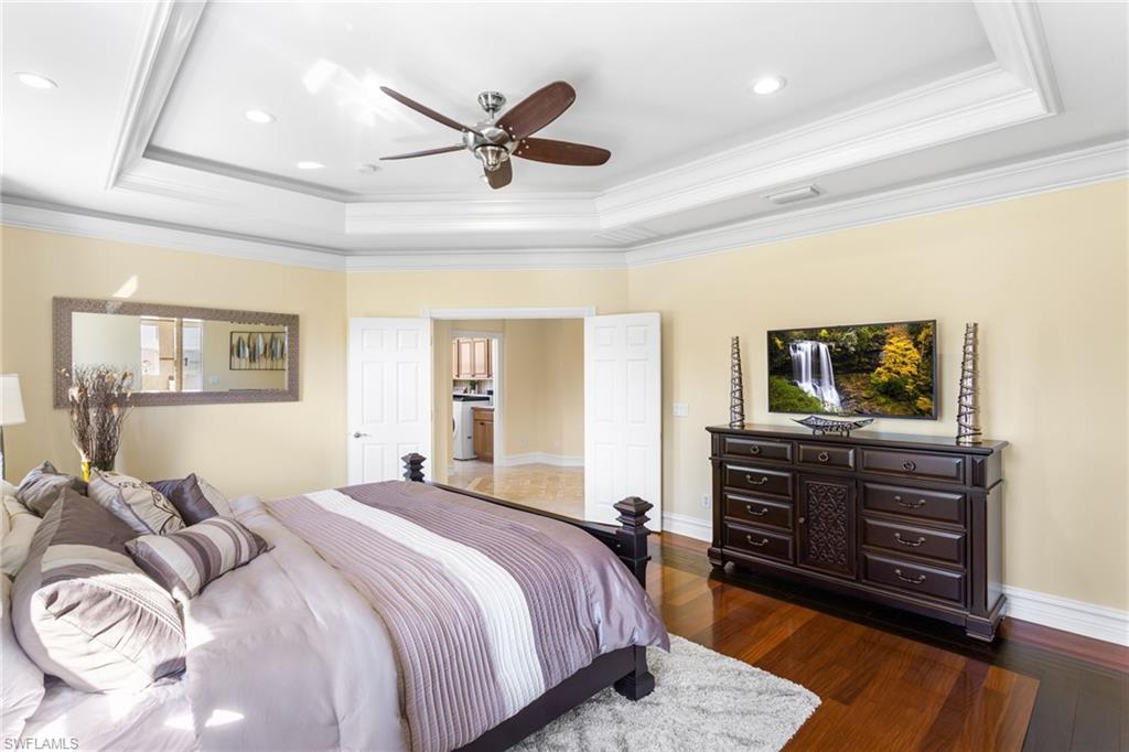 2135 Par Drive Naples, FL 34120 - Photo 19 of 46 a bedroom with a bed and wooden floor