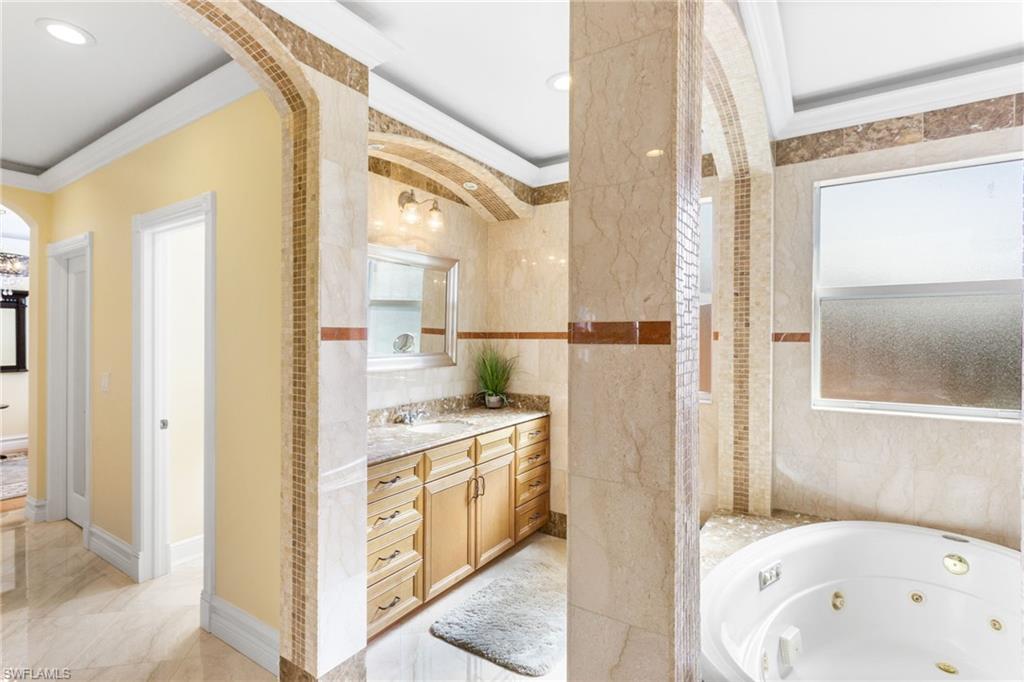 2135 Par Drive Naples, FL 34120 - Photo 21 of 46 a bathroom with a tub sink and mirror