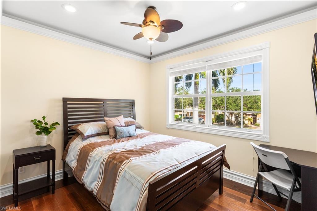 2135 Par Drive Naples, FL 34120 - Photo 25 of 46 a bedroom with a bed and a chandelier