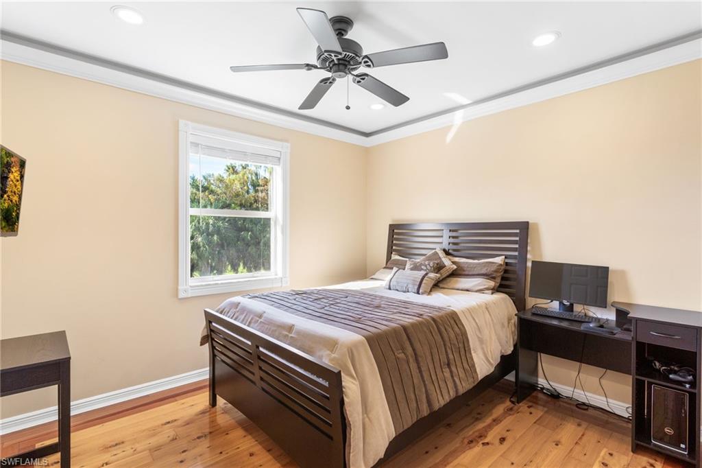 2135 Par Drive Naples, FL 34120 - Photo 26 of 46 a bedroom with a bed and a ceiling fan