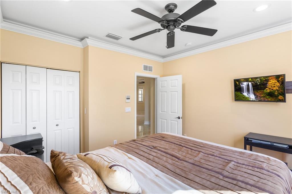 2135 Par Drive Naples, FL 34120 - Photo 27 of 46 a bedroom with a bed and a chandelier