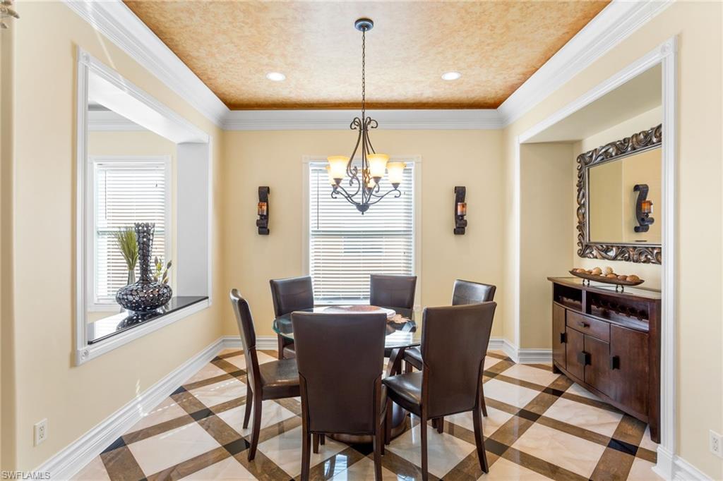 2135 Par Drive Naples, FL 34120 - Photo 32 of 46 a dining room with furniture a chandelier and wooden floor