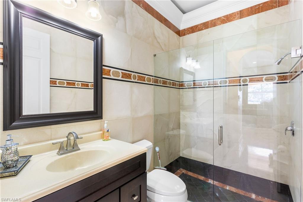 2135 Par Drive Naples, FL 34120 - Photo 33 of 46 a bathroom with a sink a toilet and shower