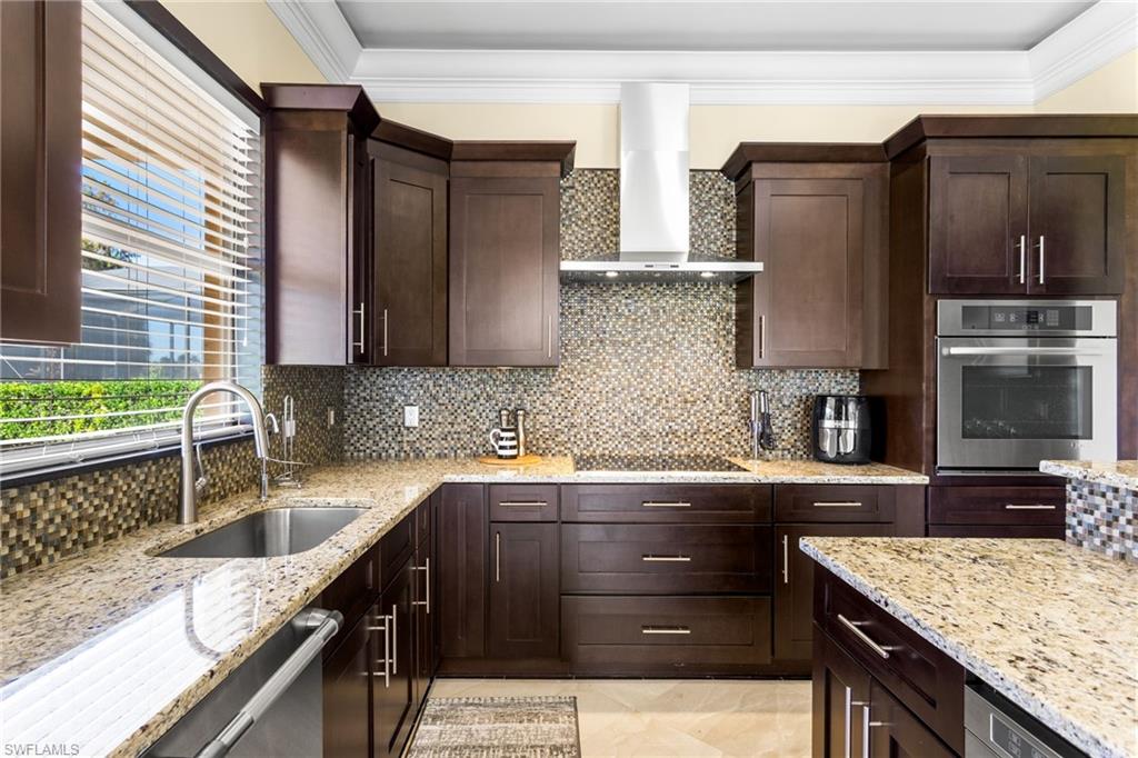 2135 Par Drive Naples, FL 34120 - Photo 37 of 46 a kitchen with granite countertop a sink stove and refrigerator