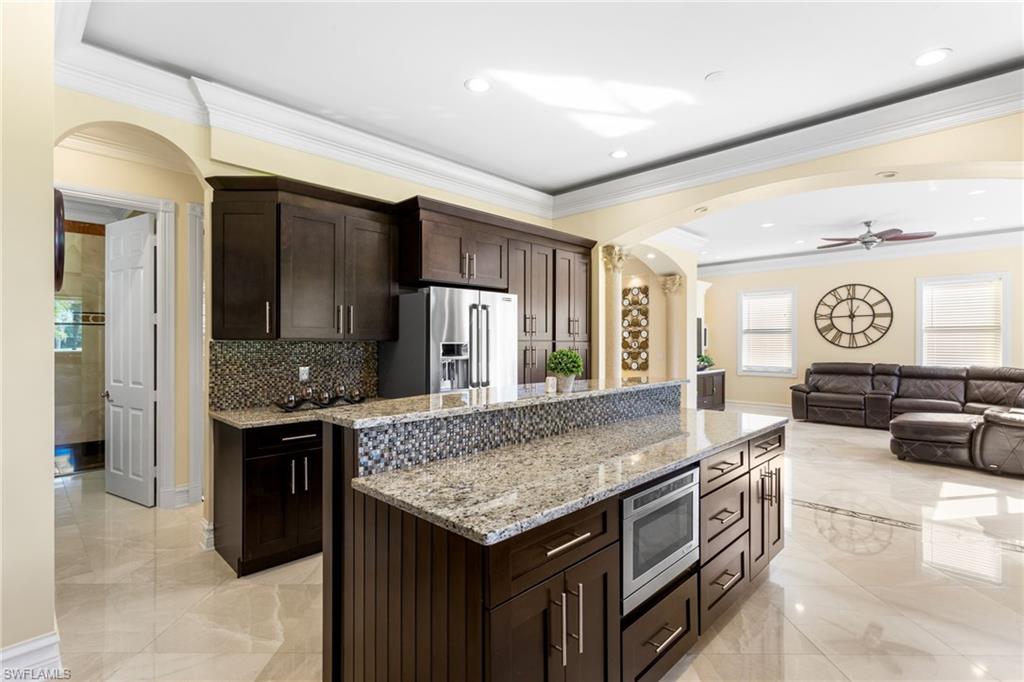 2135 Par Drive Naples, FL 34120 - Photo 45 of 46 a kitchen with stainless steel appliances granite countertop a stove and a sink