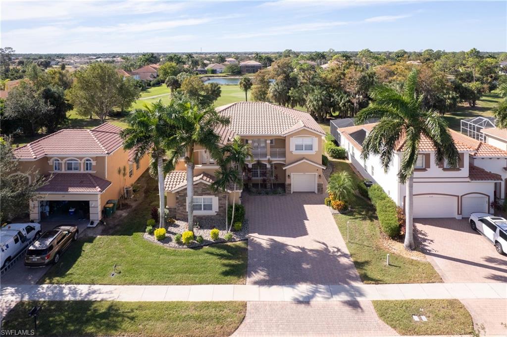 2135 Par Drive Naples, FL 34120 - Photo 42 of 46 a front view of a house with a yard and mountain