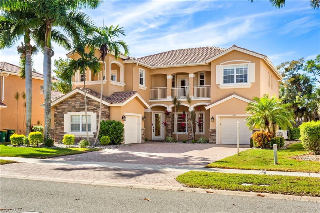 2135 Par Drive Naples, FL 34120 - Photo 43 of 46 a front view of a house with a garden
